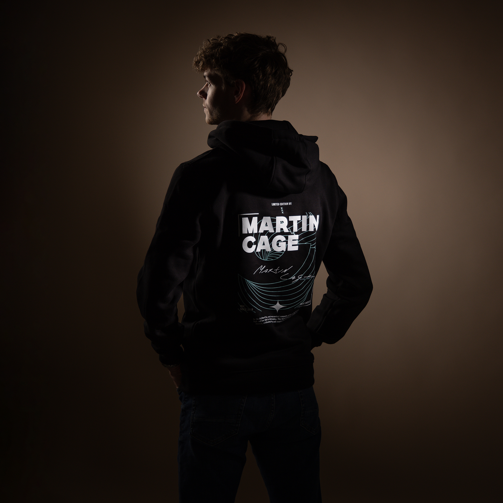 Back view of Martijn wearing a sweater with his own brand.